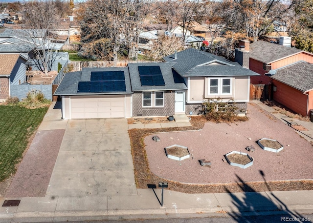 view of front of house with a garage and solar panels