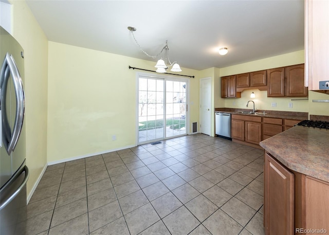 kitchen featuring hanging light fixtures, light tile patterned floors, stainless steel appliances, and an inviting chandelier