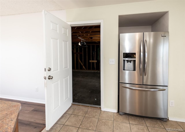 kitchen with stainless steel fridge with ice dispenser and light tile patterned floors