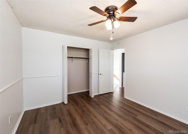 unfurnished bedroom with dark hardwood / wood-style floors, ceiling fan, a textured ceiling, and a closet