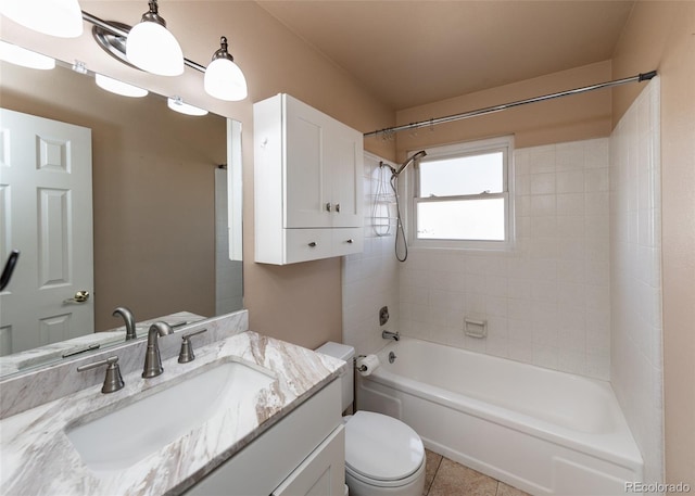 full bathroom featuring tile patterned floors, vanity, tiled shower / bath combo, and toilet