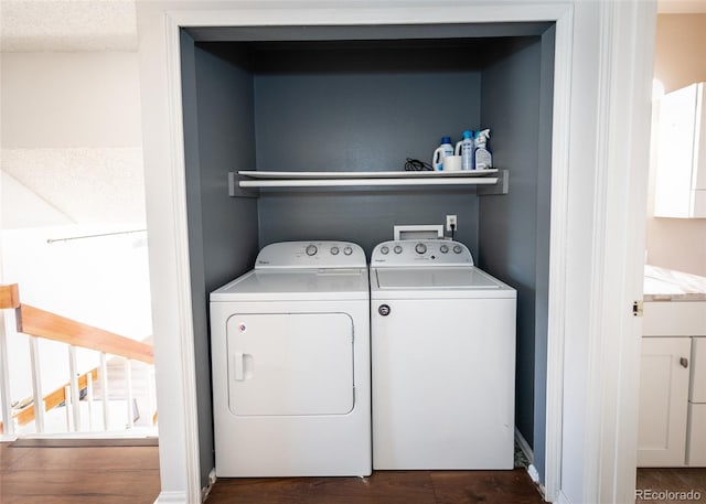 clothes washing area with dark wood-type flooring and washing machine and clothes dryer