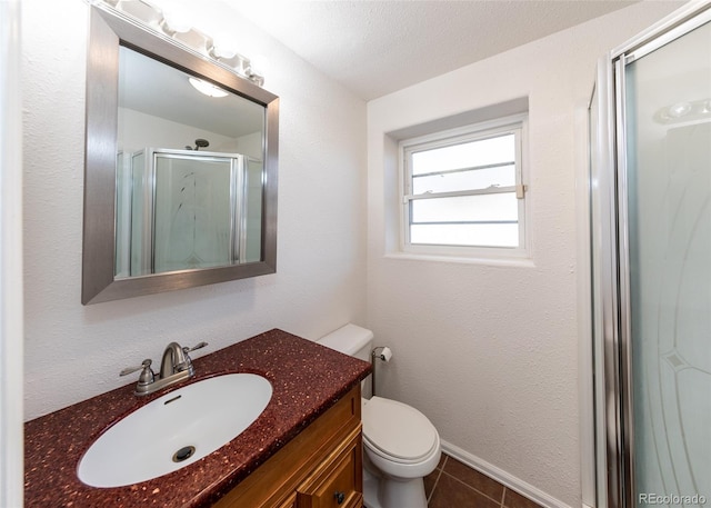 bathroom featuring tile patterned flooring, a textured ceiling, toilet, vanity, and a shower with shower door