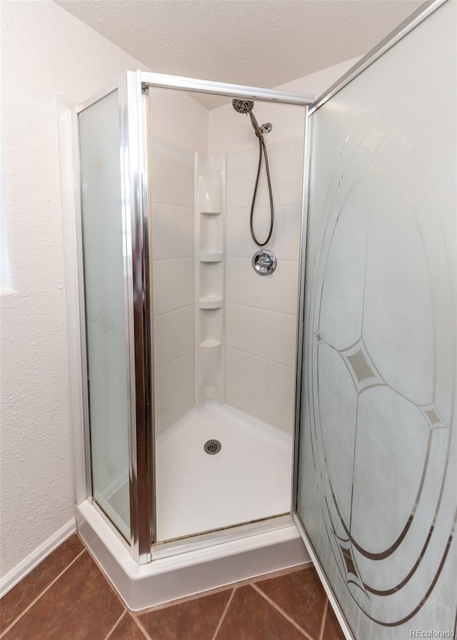 bathroom with tile patterned flooring and a shower with door