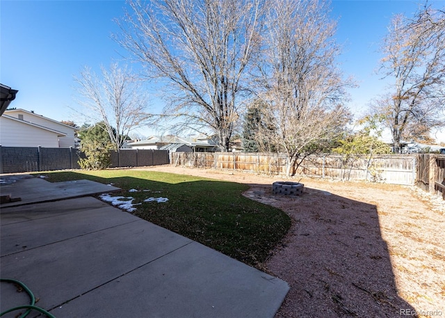 view of yard featuring an outdoor fire pit and a patio area