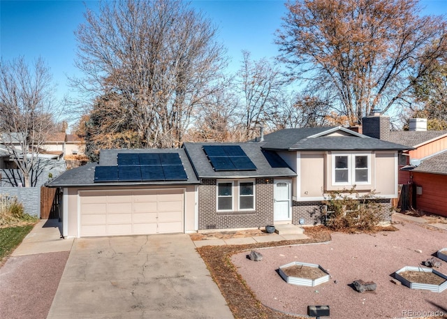 view of front of home featuring a garage and solar panels