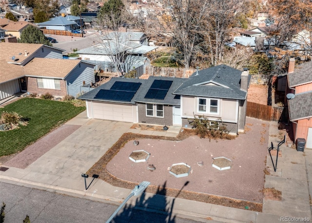 view of front of property with solar panels and a garage