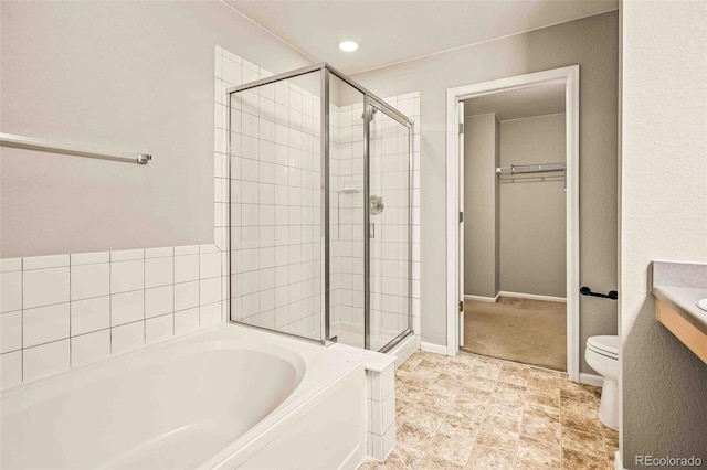 full bathroom featuring shower with separate bathtub, vanity, and toilet