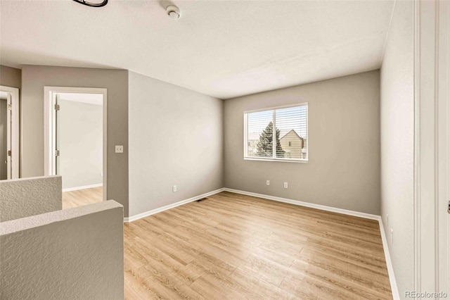 spare room featuring light hardwood / wood-style floors