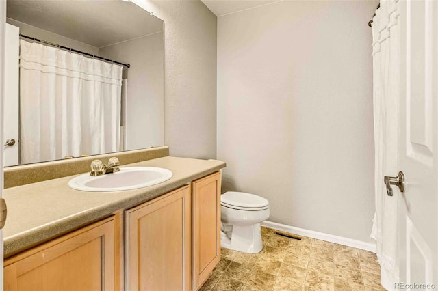 bathroom featuring vanity and toilet