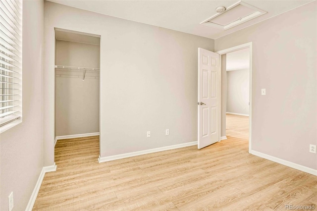 unfurnished bedroom with light hardwood / wood-style floors and a closet