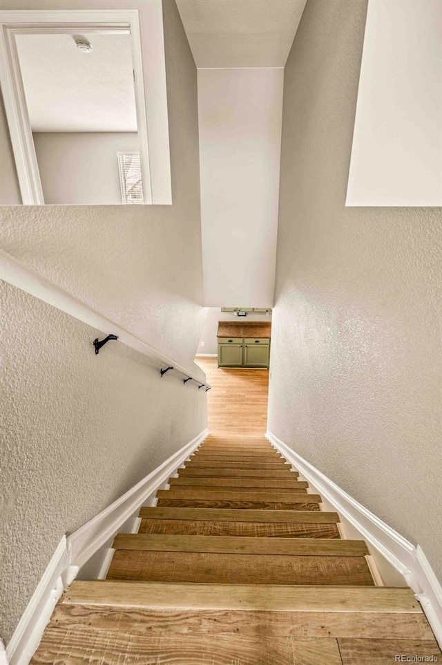 stairway featuring hardwood / wood-style floors