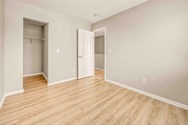 unfurnished bedroom with a closet and light hardwood / wood-style flooring