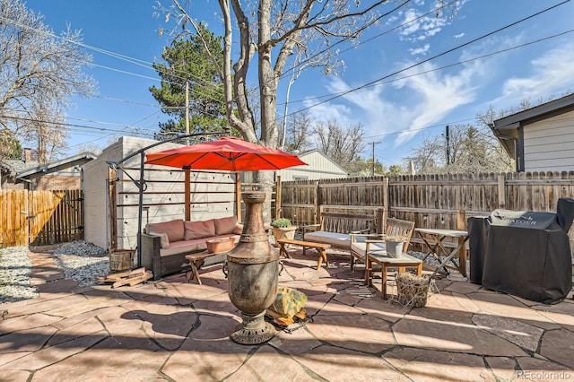 view of patio featuring an outdoor living space and a fenced backyard