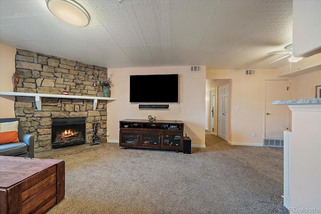13393 E Asbury Dr Unit 103, Aurora, CO 80014 - living room featuring a stone fireplace, ceiling fan, and carpet
