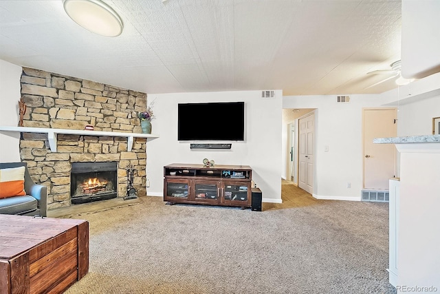 13393 E Asbury Dr Unit 103, Aurora, CO 80014 - living area with a stone fireplace, carpet, and a ceiling fan