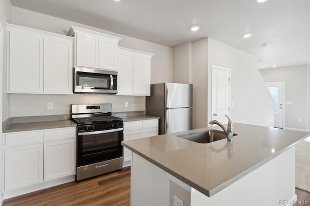 kitchen featuring white cabinets, dark hardwood / wood-style flooring, an island with sink, sink, and stainless steel appliances