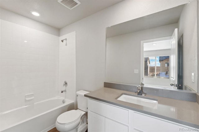 full bathroom featuring vanity, toilet, and tiled shower / bath