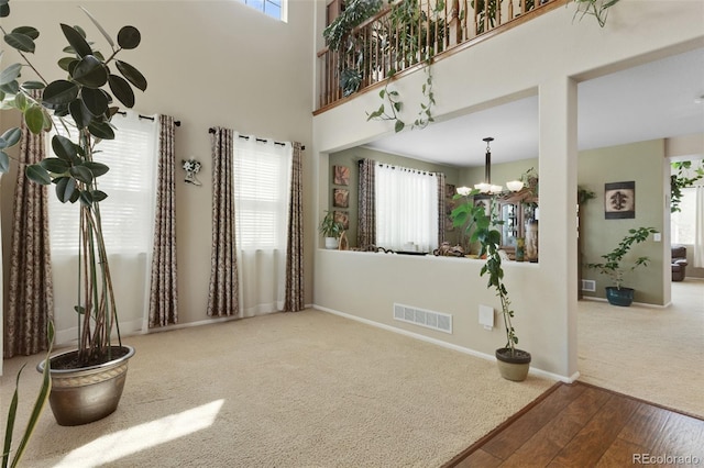13415 Kearney St, Thornton, CO 80602 - carpeted empty room featuring wood-type flooring, a chandelier, healthy amount of natural light, and baseboards