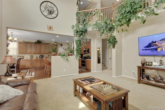 13415 Kearney St, Thornton, CO 80602 - living room featuring a high ceiling, light colored carpet, a chandelier, baseboards, and recessed lighting