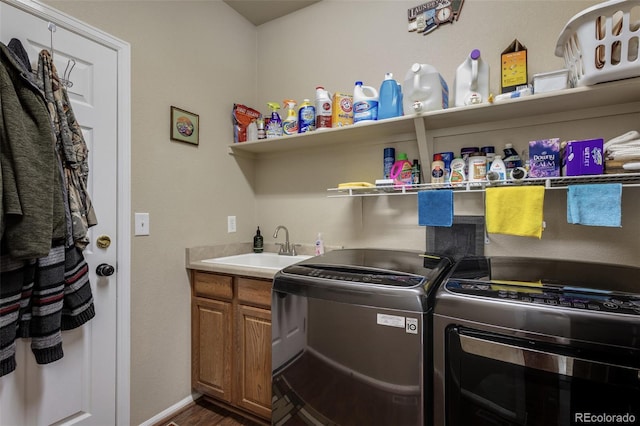 13415 Kearney St, Thornton, CO 80602 - washroom with independent washer and dryer, dark wood finished floors, cabinet space, and baseboards