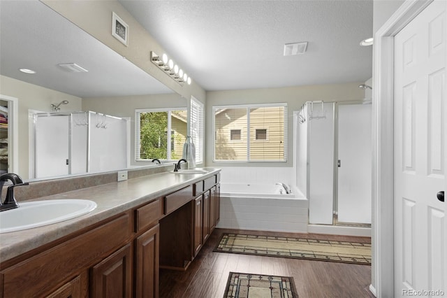 13415 Kearney St, Thornton, CO 80602 - bathroom with a shower stall, a bath, double vanity, wood finished floors, and a closet