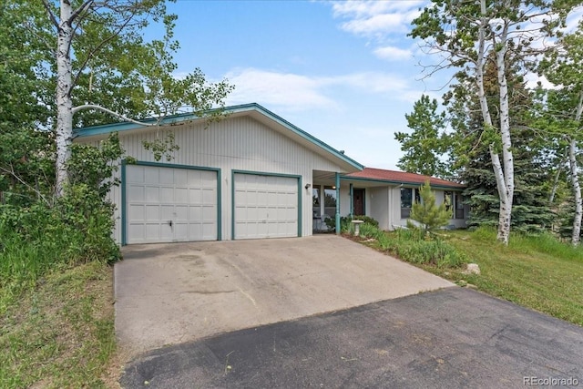 8427 S Custer Ln, Evergreen, CO 80439 - ranch-style home with an attached garage and concrete driveway