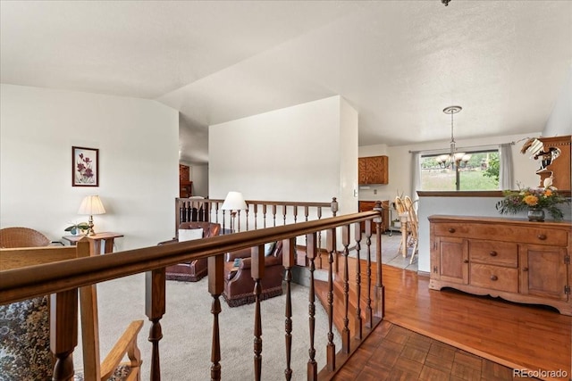 8427 S Custer Ln, Evergreen, CO 80439 - corridor with a chandelier, an upstairs landing, and dark wood-style floors