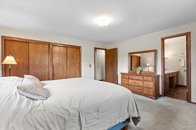 8427 S Custer Ln, Evergreen, CO 80439 - bedroom with light carpet, ensuite bathroom, and multiple closets