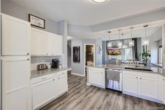 kitchen featuring dishwasher, hanging light fixtures, white cabinets, light stone counters, and light hardwood / wood-style floors