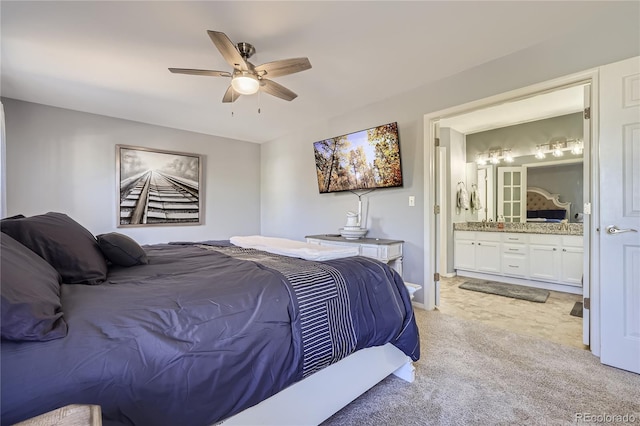 bedroom with light carpet, ensuite bathroom, and ceiling fan