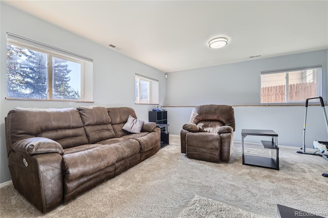 carpeted living room featuring plenty of natural light