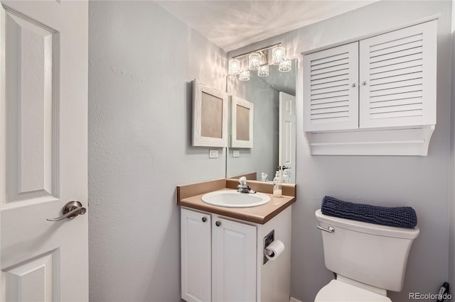 bathroom with toilet and vanity