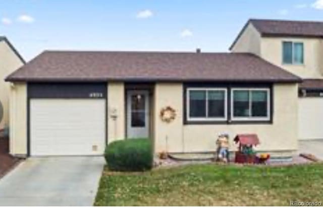4935 Elm Grove Dr, Colorado Springs, CO 80911 - view of front of property with a garage, concrete driveway, and stucco siding