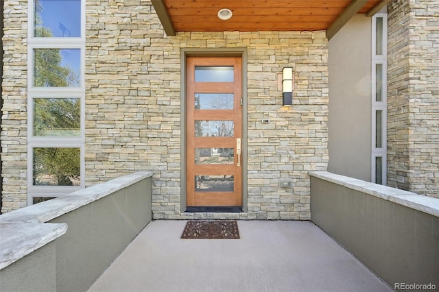 view of exterior entry featuring stone siding