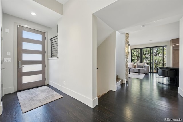entrance foyer featuring baseboards, recessed lighting, stairs, and dark wood finished floors