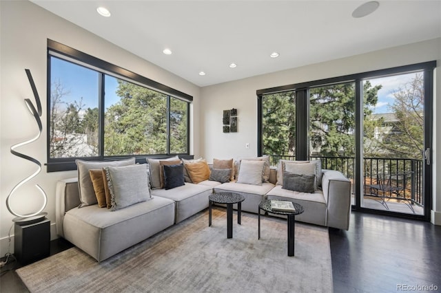 living room featuring wood finished floors, recessed lighting, and a healthy amount of sunlight