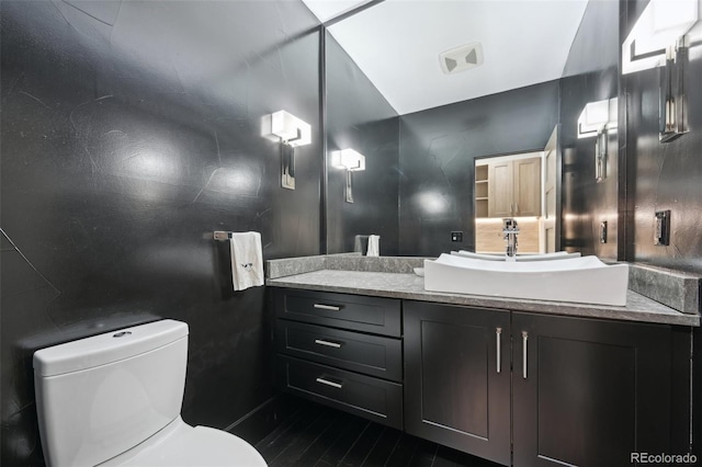 bathroom with toilet and vanity