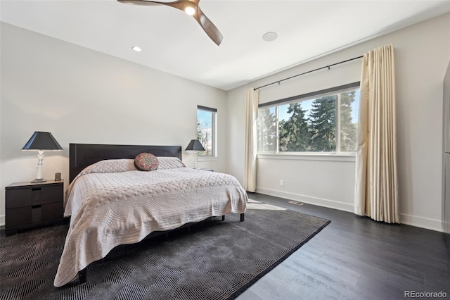 bedroom with wood finished floors, baseboards, and ceiling fan