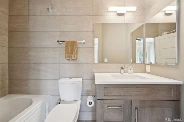 bathroom with a tub to relax in, tile walls, toilet, and vanity