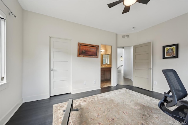 home office featuring baseboards, visible vents, ceiling fan, and dark wood-style flooring