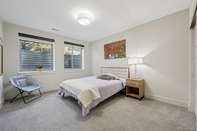 bedroom featuring baseboards, visible vents, and carpet