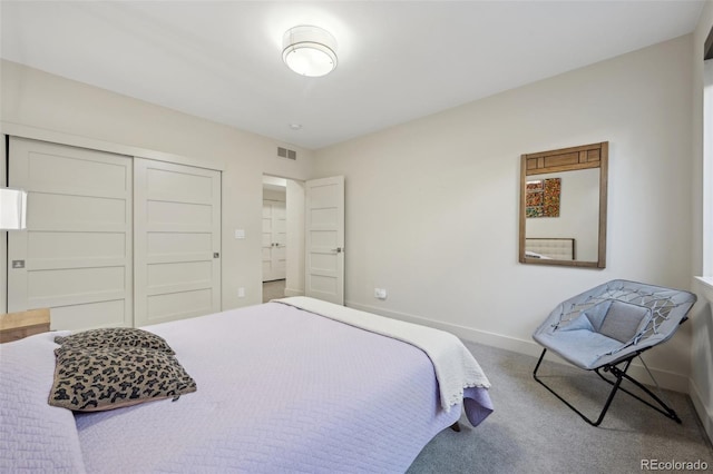 bedroom with a closet, carpet, visible vents, and baseboards