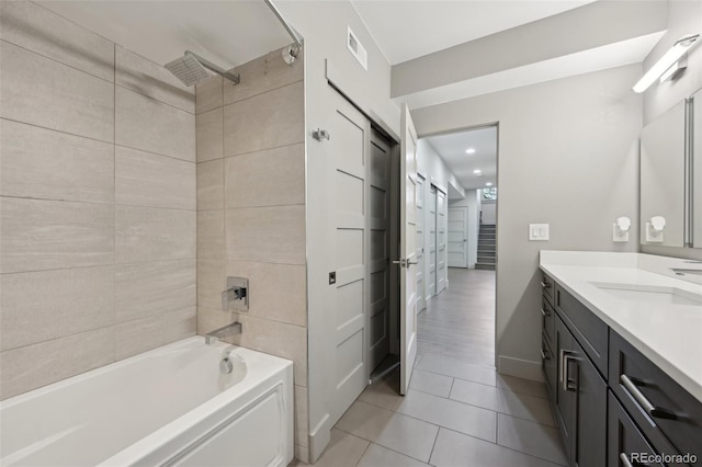 bathroom featuring shower / washtub combination, visible vents, tile patterned flooring, and vanity
