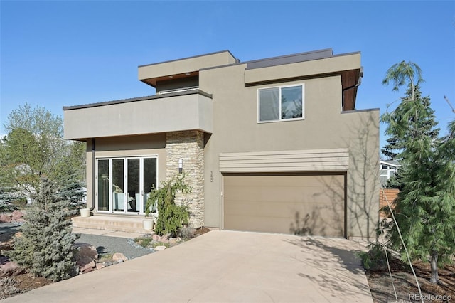 modern home with a balcony, concrete driveway, stone siding, a garage, and stucco siding