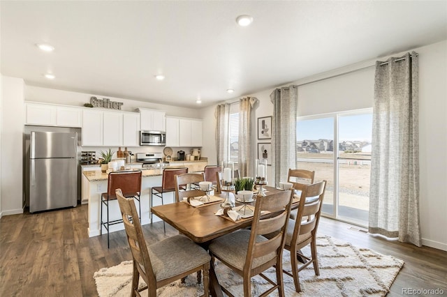 dining space with dark hardwood / wood-style floors