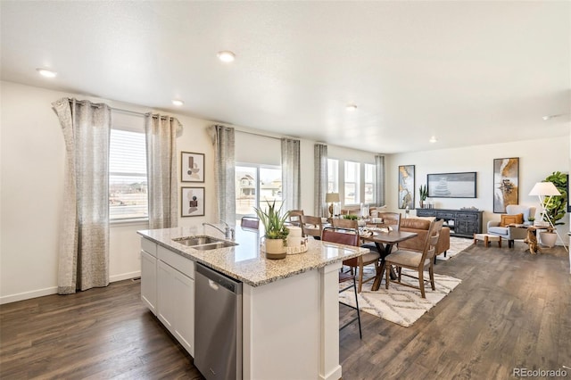 kitchen with dishwasher, white cabinetry, plenty of natural light, sink, and a kitchen island with sink