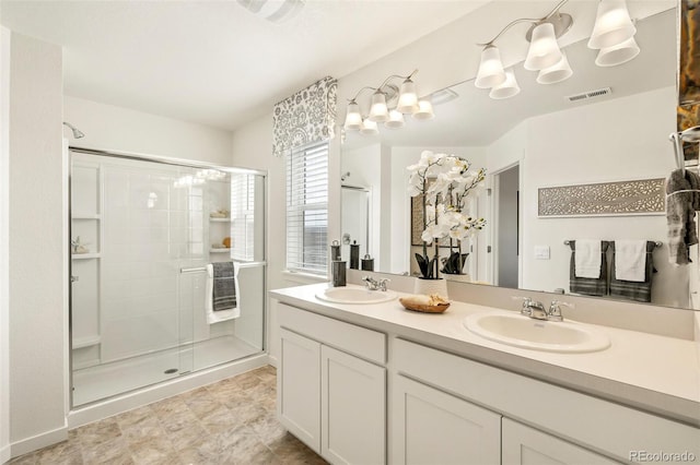 bathroom with a shower with shower door and vanity