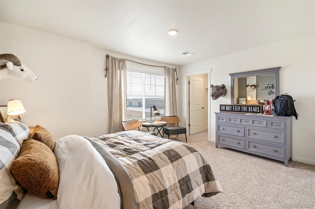 bedroom with light colored carpet