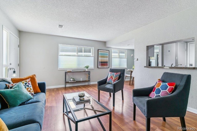 6650 E Arizona Ave Unit 154, Denver, CO 80224 - living room with a textured ceiling, wood finished floors, plenty of natural light, and baseboards